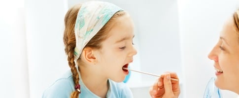 young girl getting a strep throat swab test